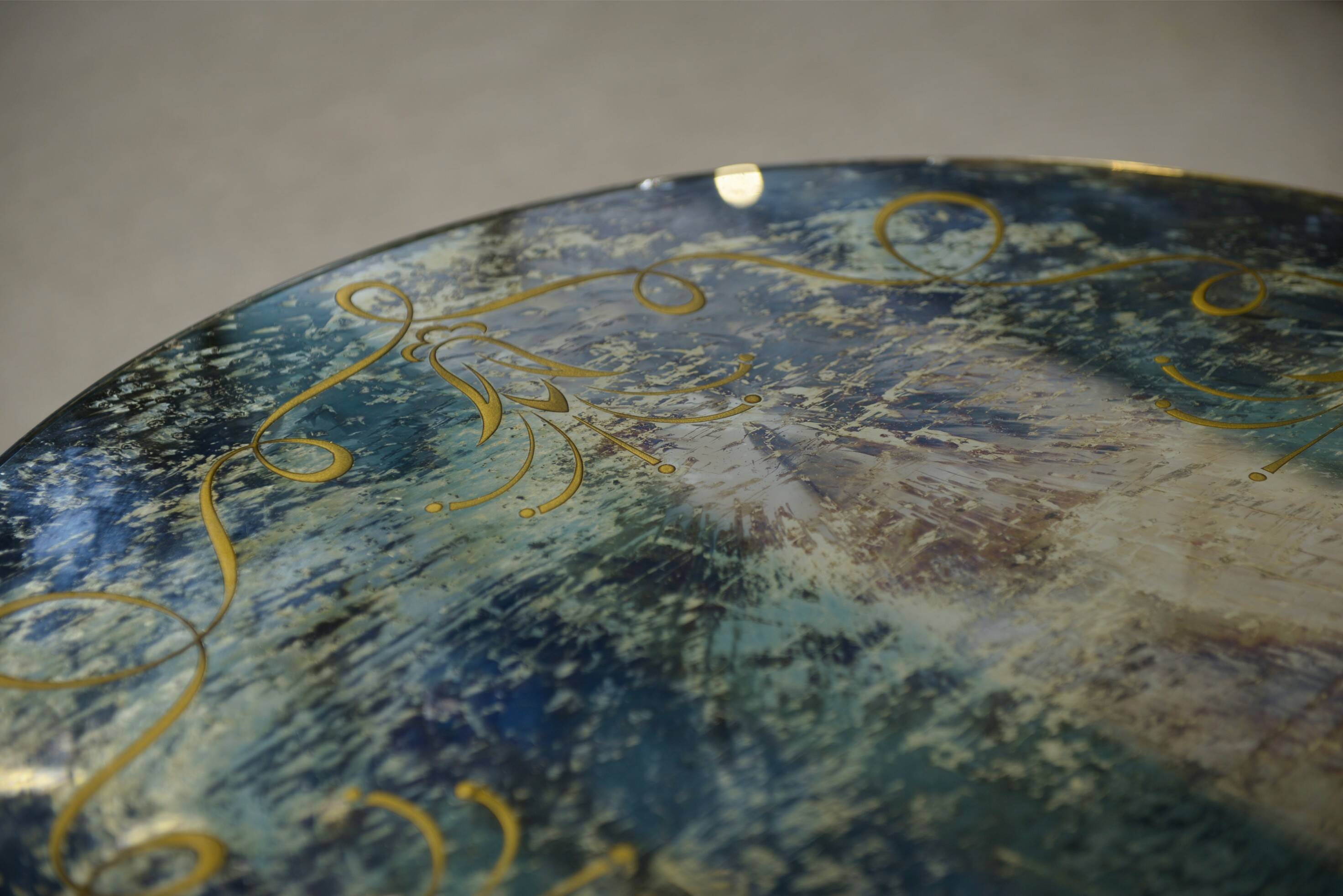 Neo-classical cast iron and glass eglomisé coffee table from the 1940s.