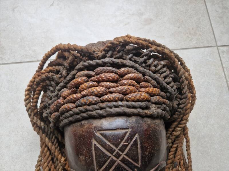 Chokwe Mwana Pwo mask in carved wood with a dark patina and rope hair