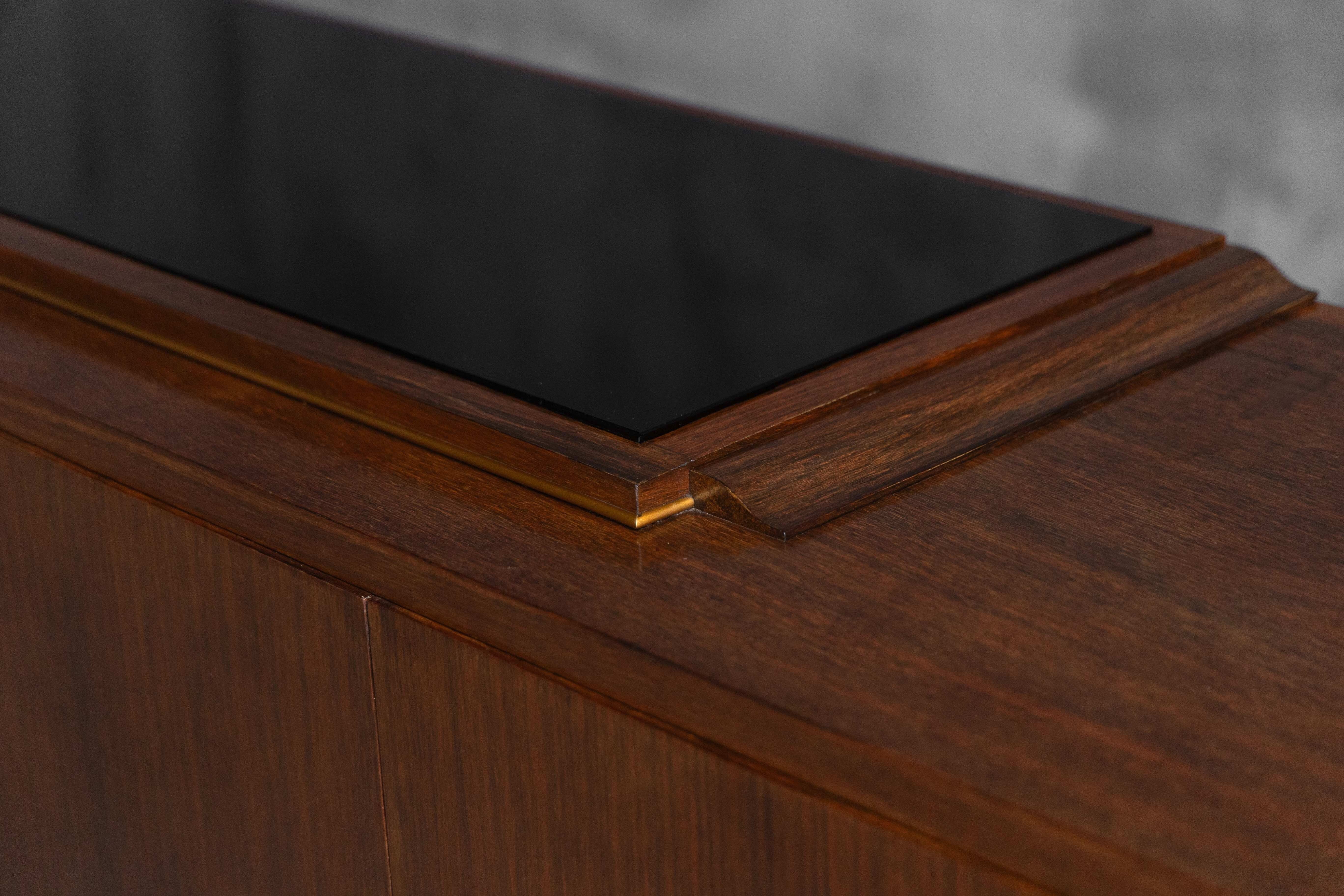 Art Deco walnut sideboard with brass details and sculptural base, France, 1930s