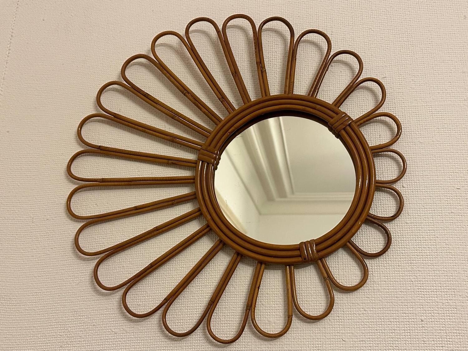 Old vintage asymmetrical round rattan mirror