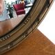 Old oval mirror with a pediment