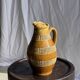 Vintage yellow stoneware carafe with beaded friezes Made in France H22