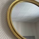 Round mirror with golden wood frame