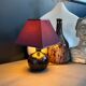 Ceramic floor lamp with a pyramidal shade and square base.