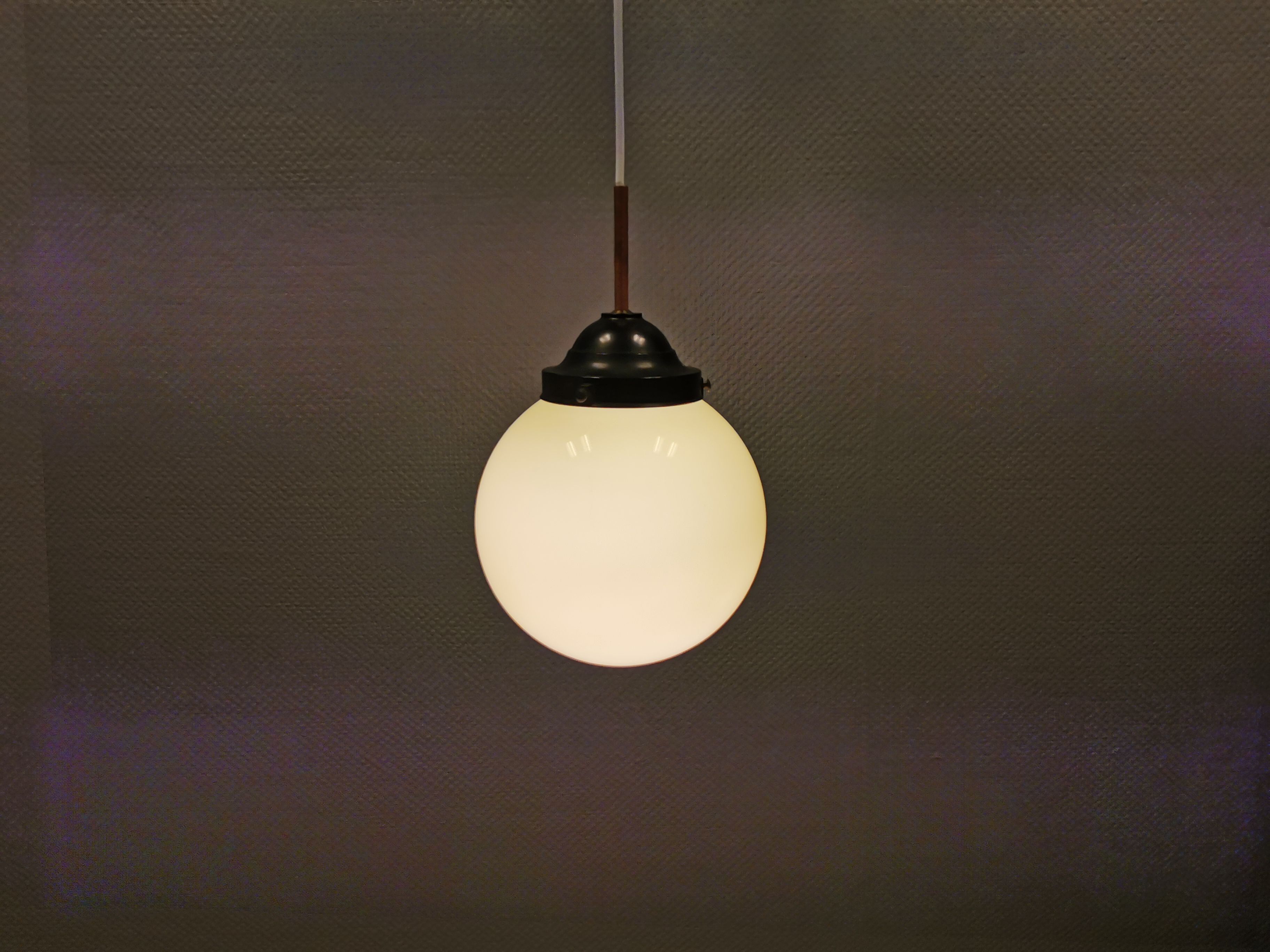 Small Art Deco hanging lamp in cream coloured glass and bakelite top.