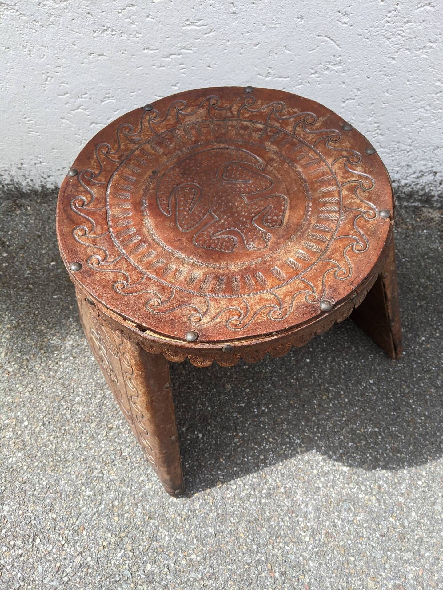 Wood and leather stool, handcrafted African art.