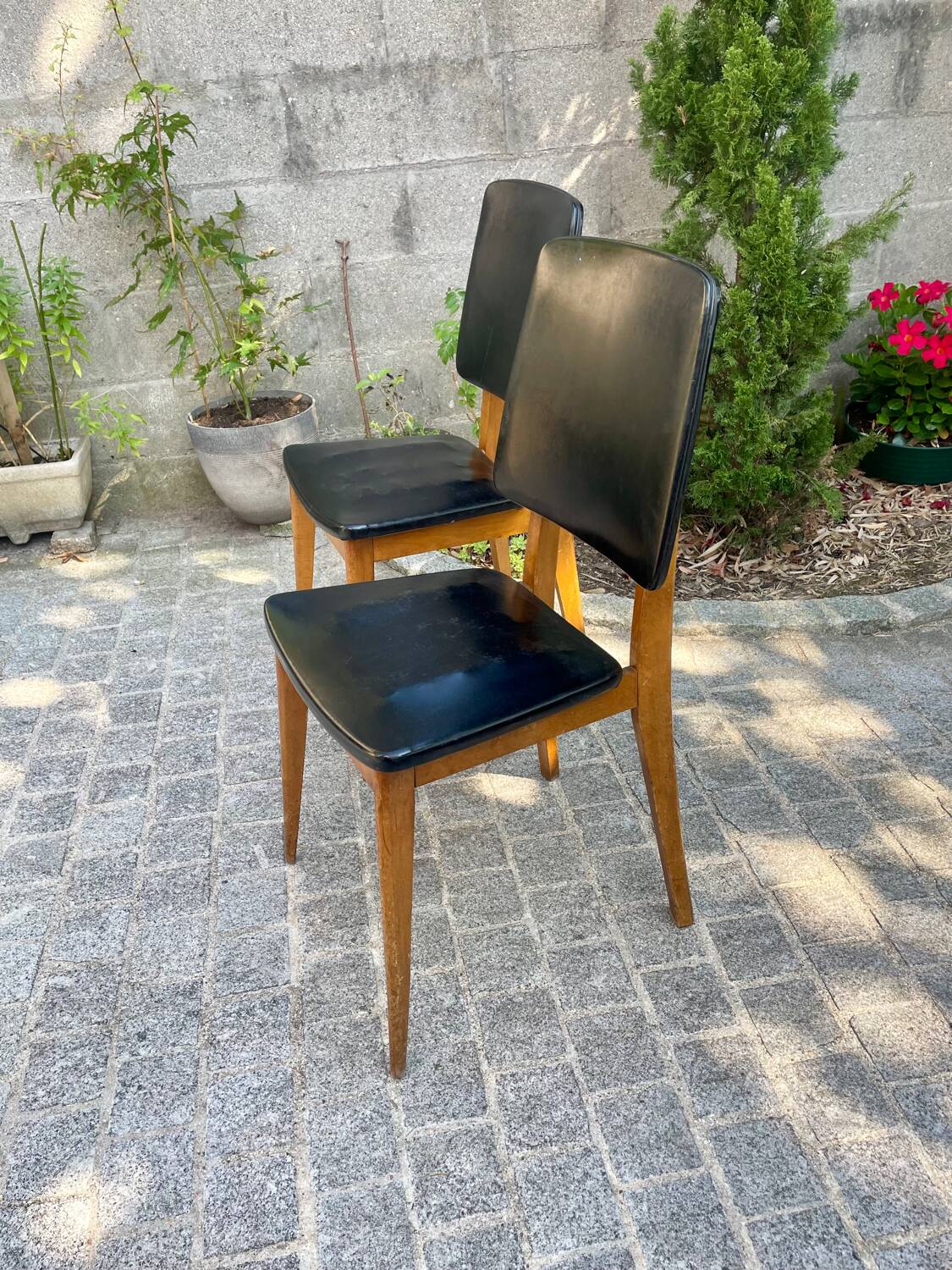 Two vintage Scandinavian chairs in beech and black leatherette