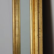 Baroque mantel mirror in carved wood and gilded plaster, France circa 1850.