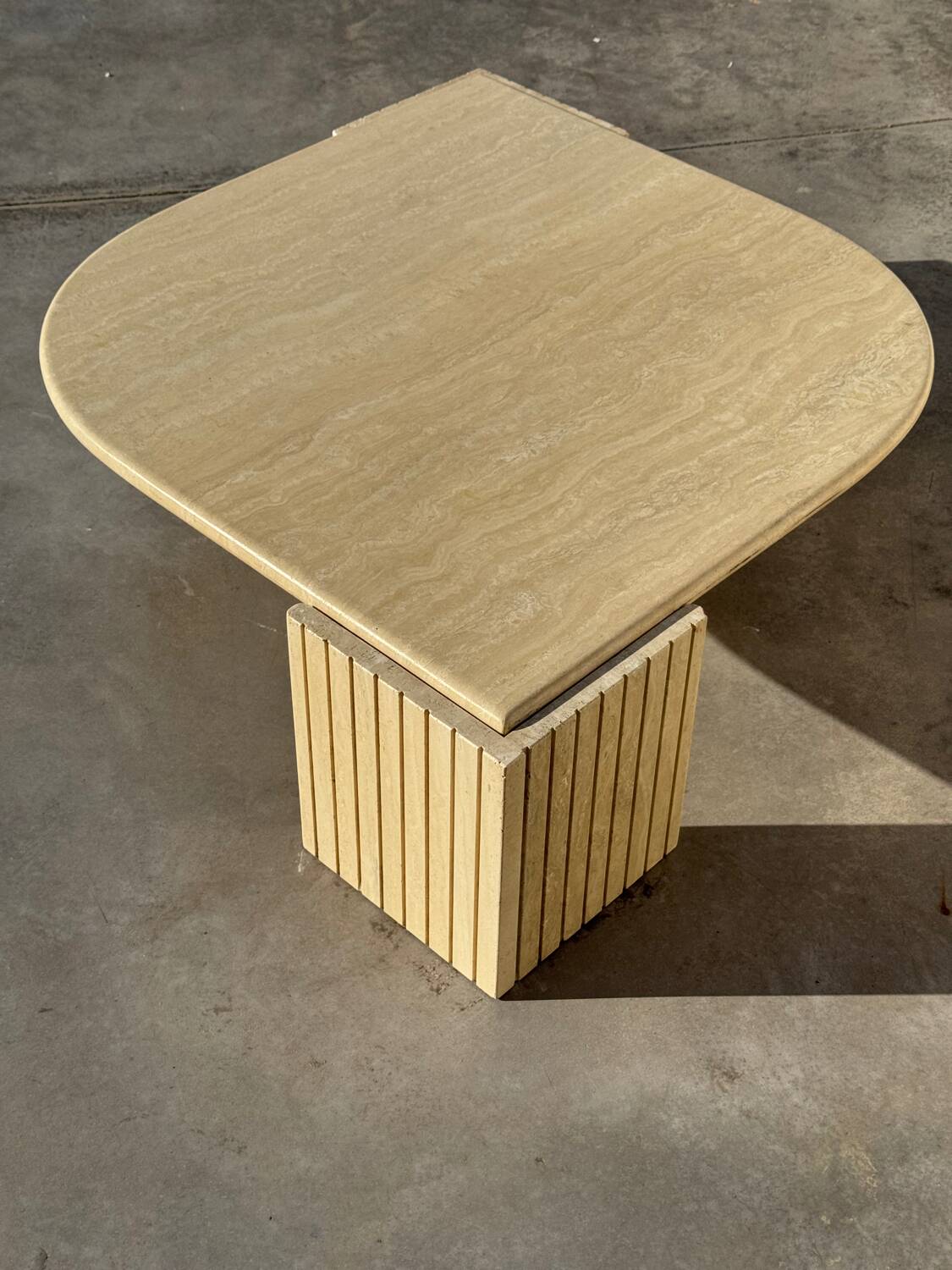 Large designer coffee table in travertine, eye shape, Roche Bobois edition from the 80s