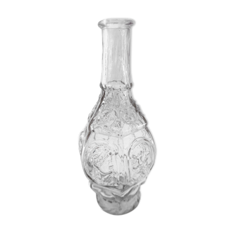 Commemorative bottle of blown glass molded with these characters in reliefs before 1900