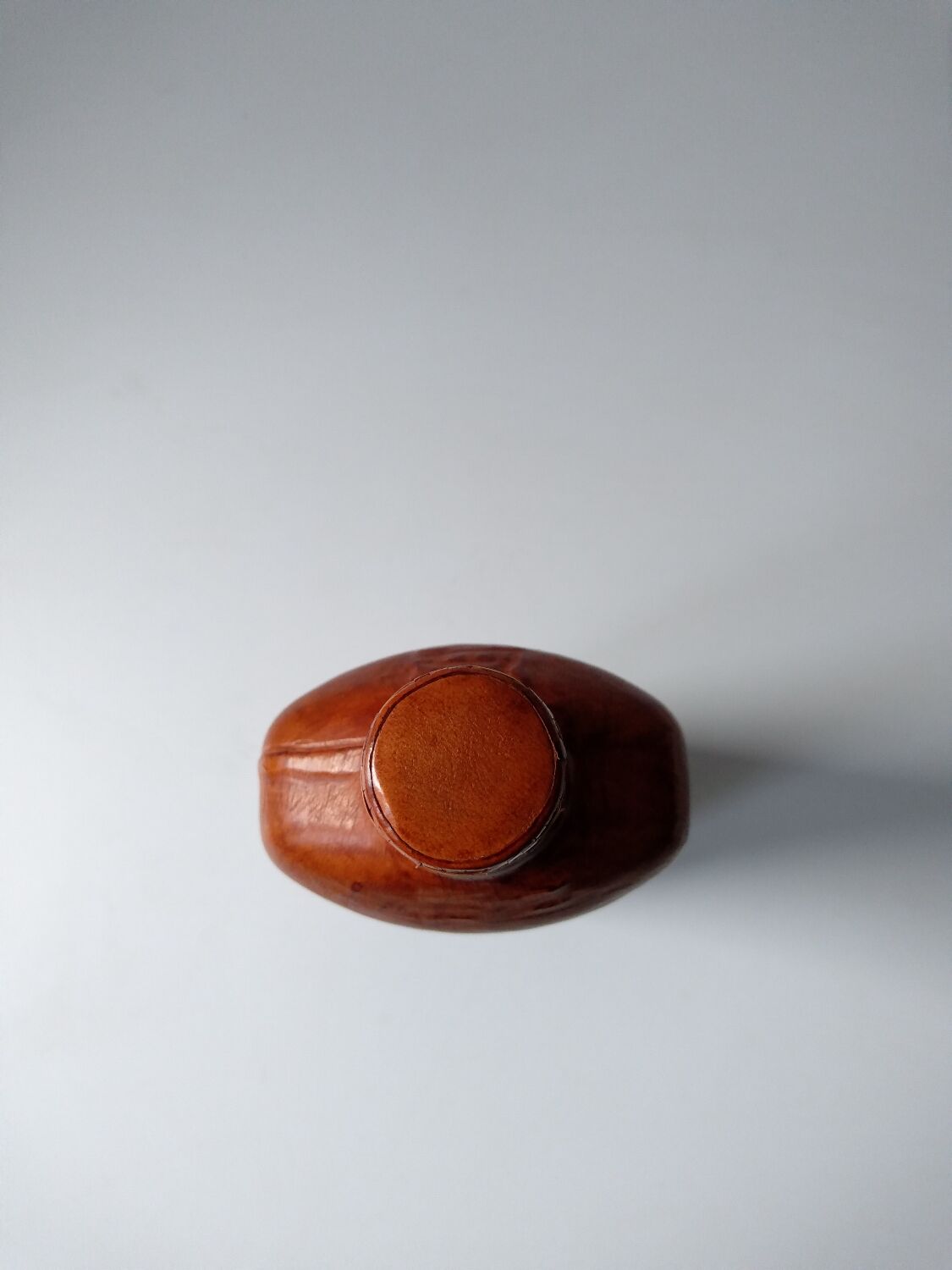 Vintage glass bottle covered with light brown leather and wicker