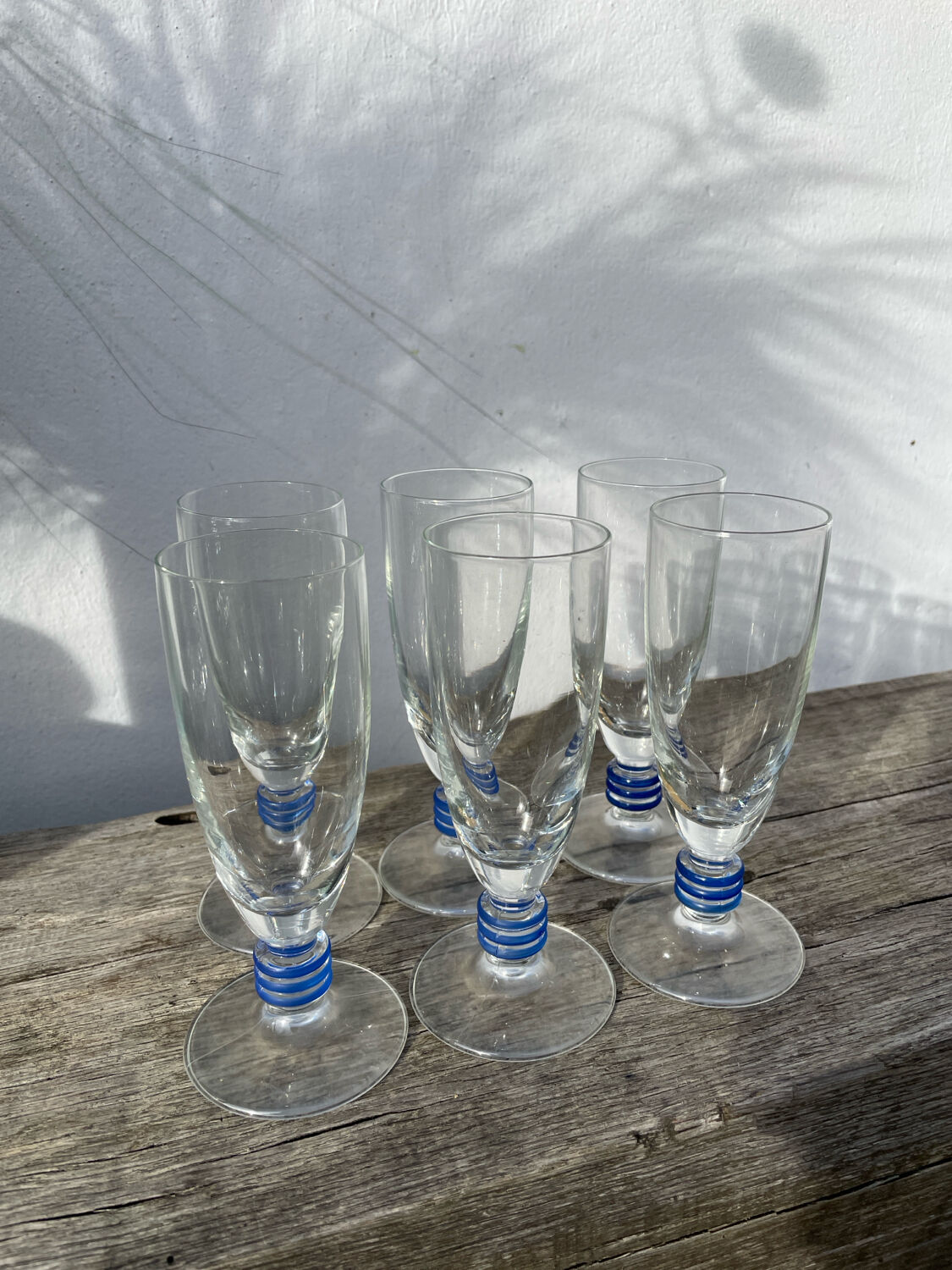 6 clear champagne flutes with blue stems, designer style