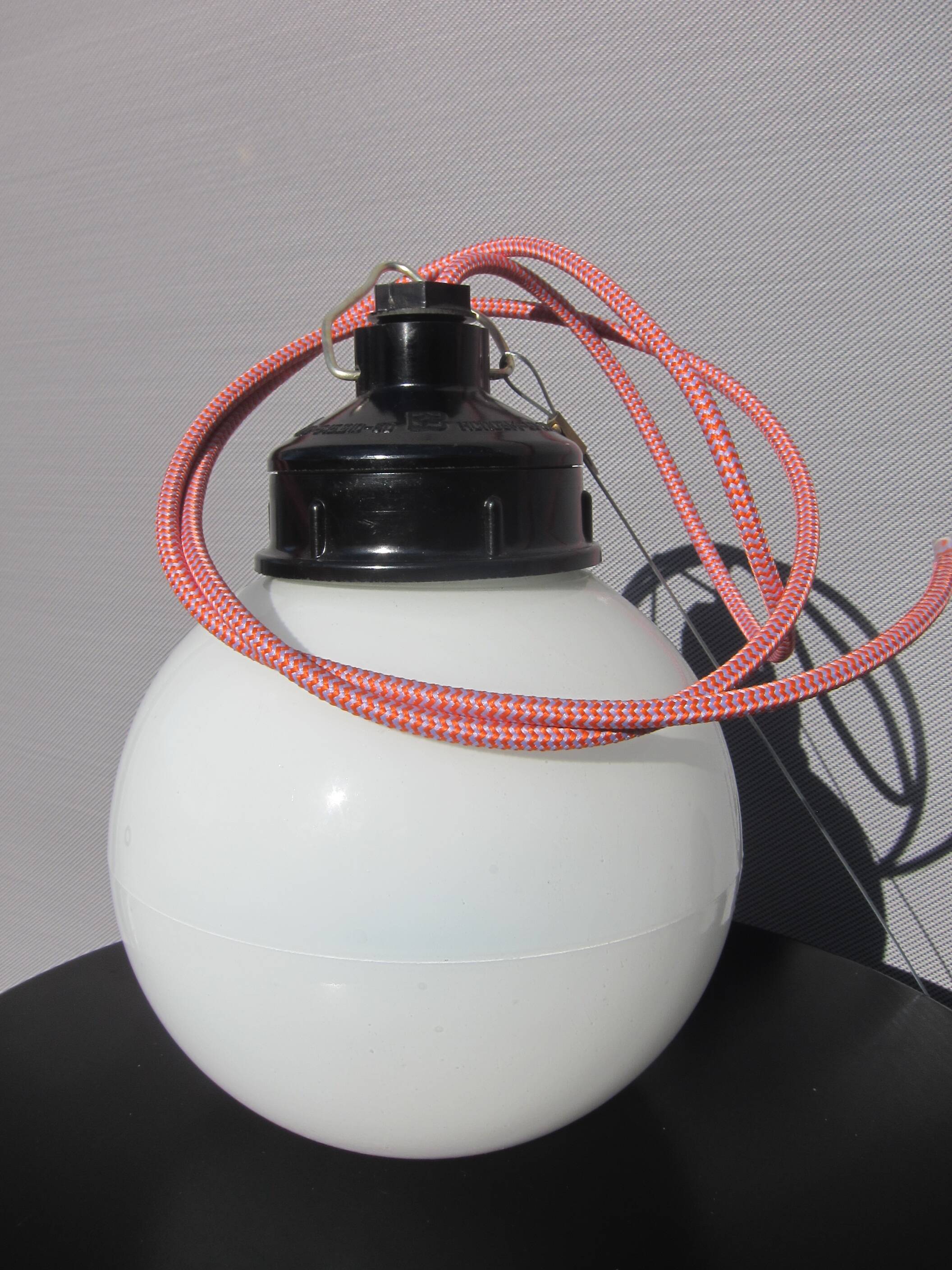 Trio of opal glass and bakelite globe pendant lights