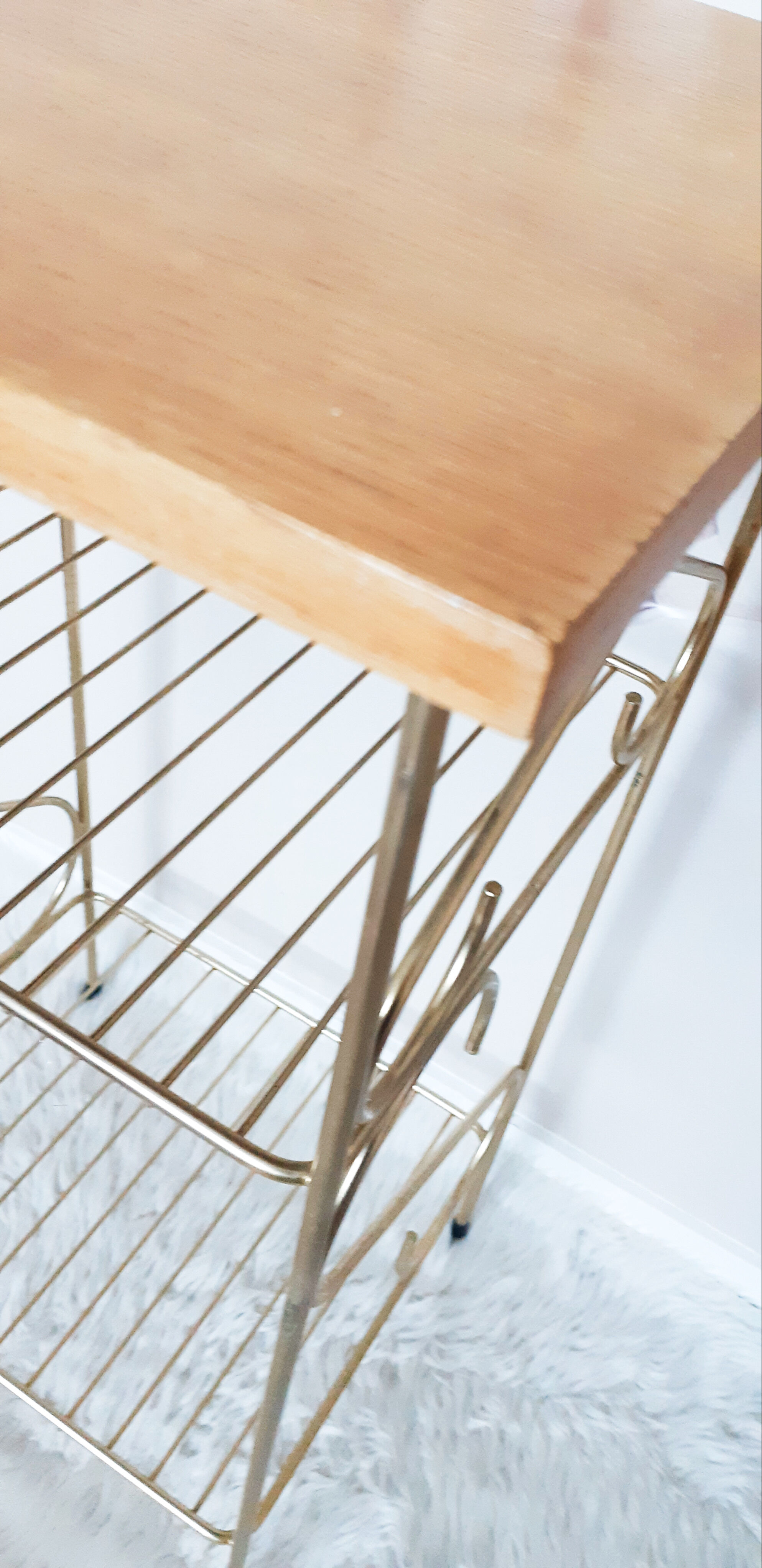 Side table with a golden magazine holder