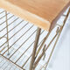 Side table with a golden magazine holder