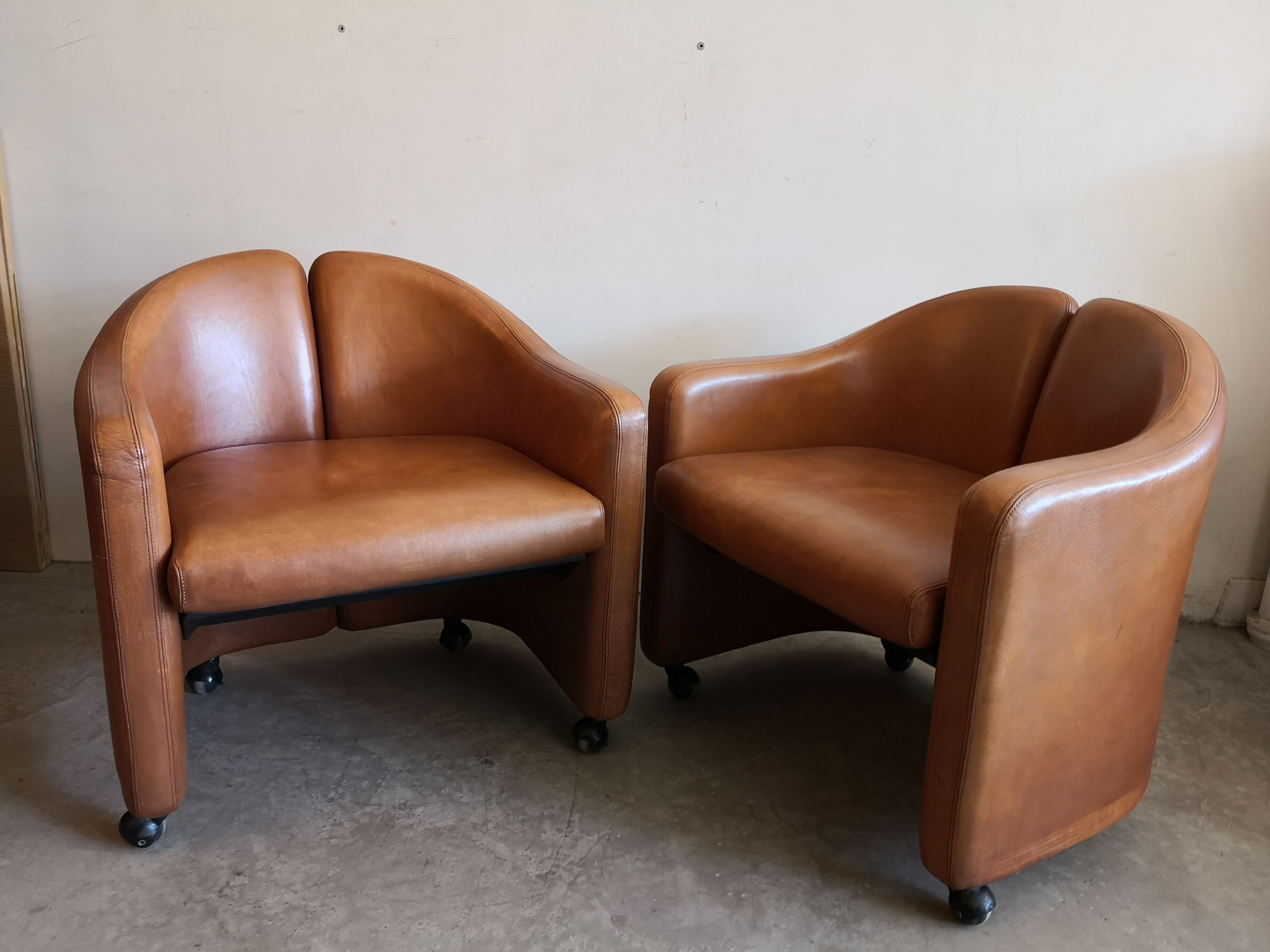 Pair of leather armchairs by Eugenio Gerli