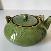 Vintage green teapot with lotus decoration and bamboo handle.