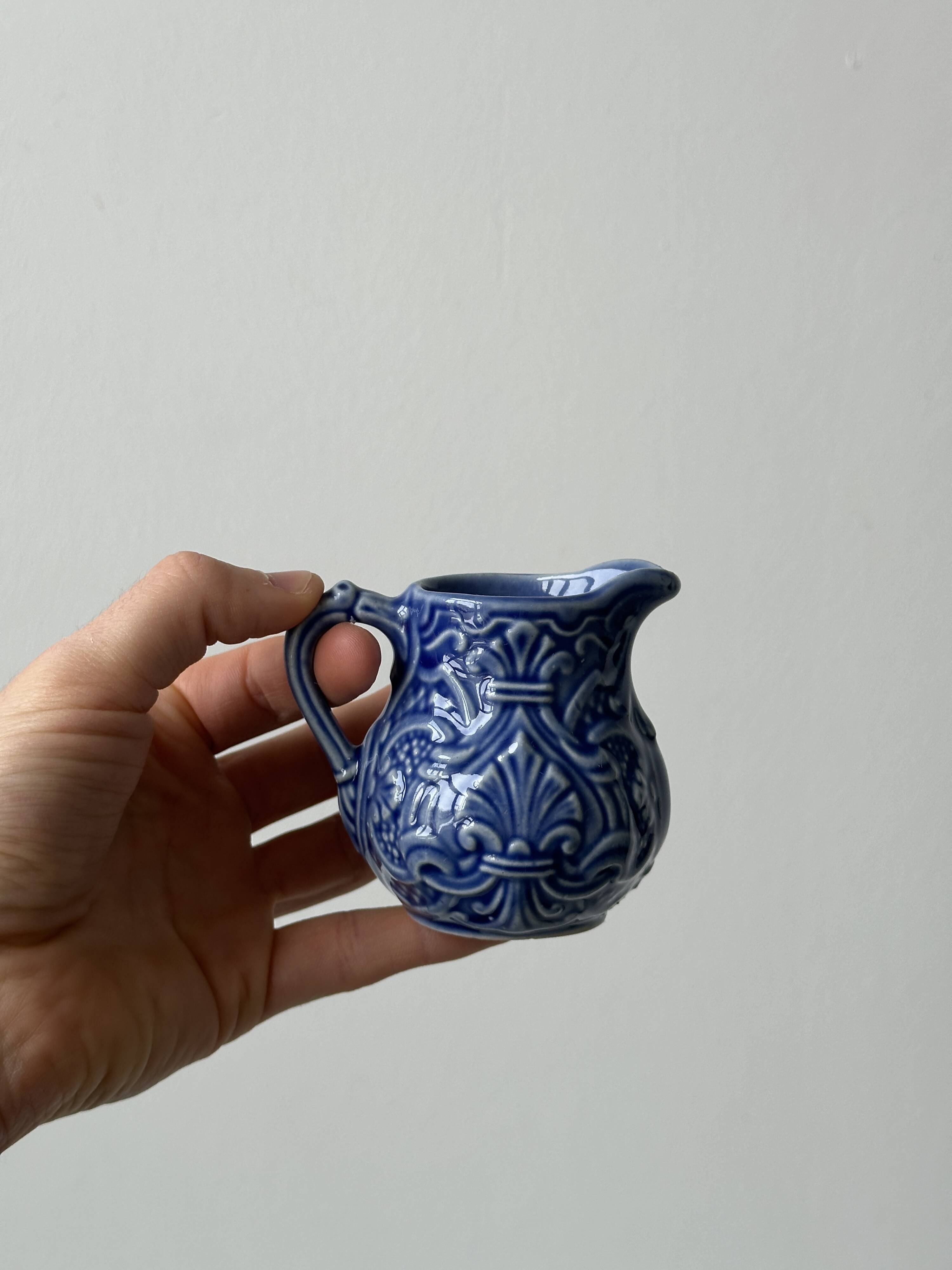 Old cream milk jug in slip