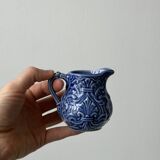 Old cream milk jug in slip