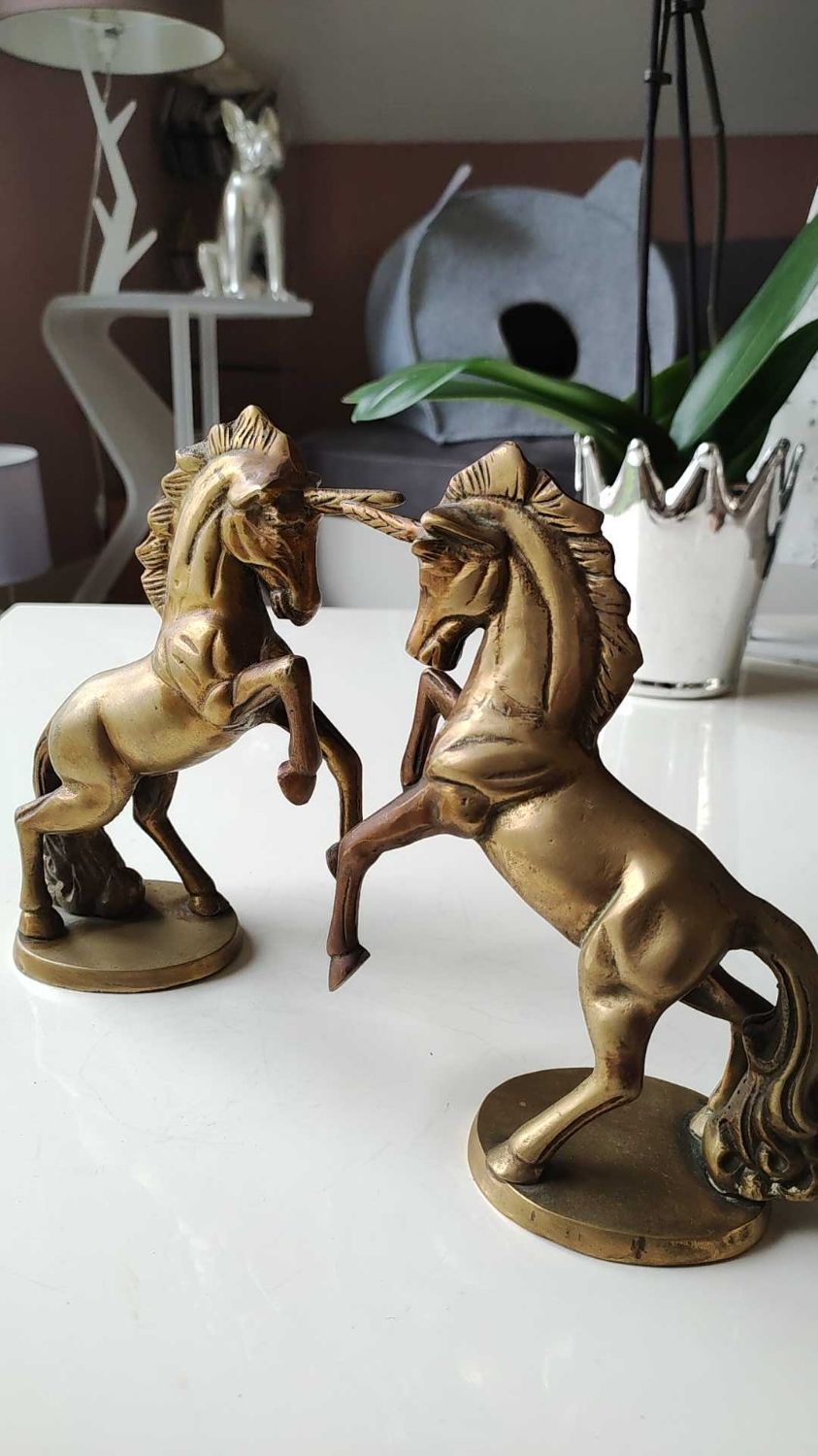 of greenhouse art deco bookends recancing unicorns. solid brass