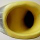Earthenware vase decorated with yellow lines on a black and yellow background