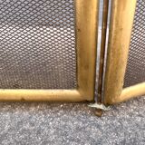 Antique brass fireplace screen from 1920, vintage spark guard.