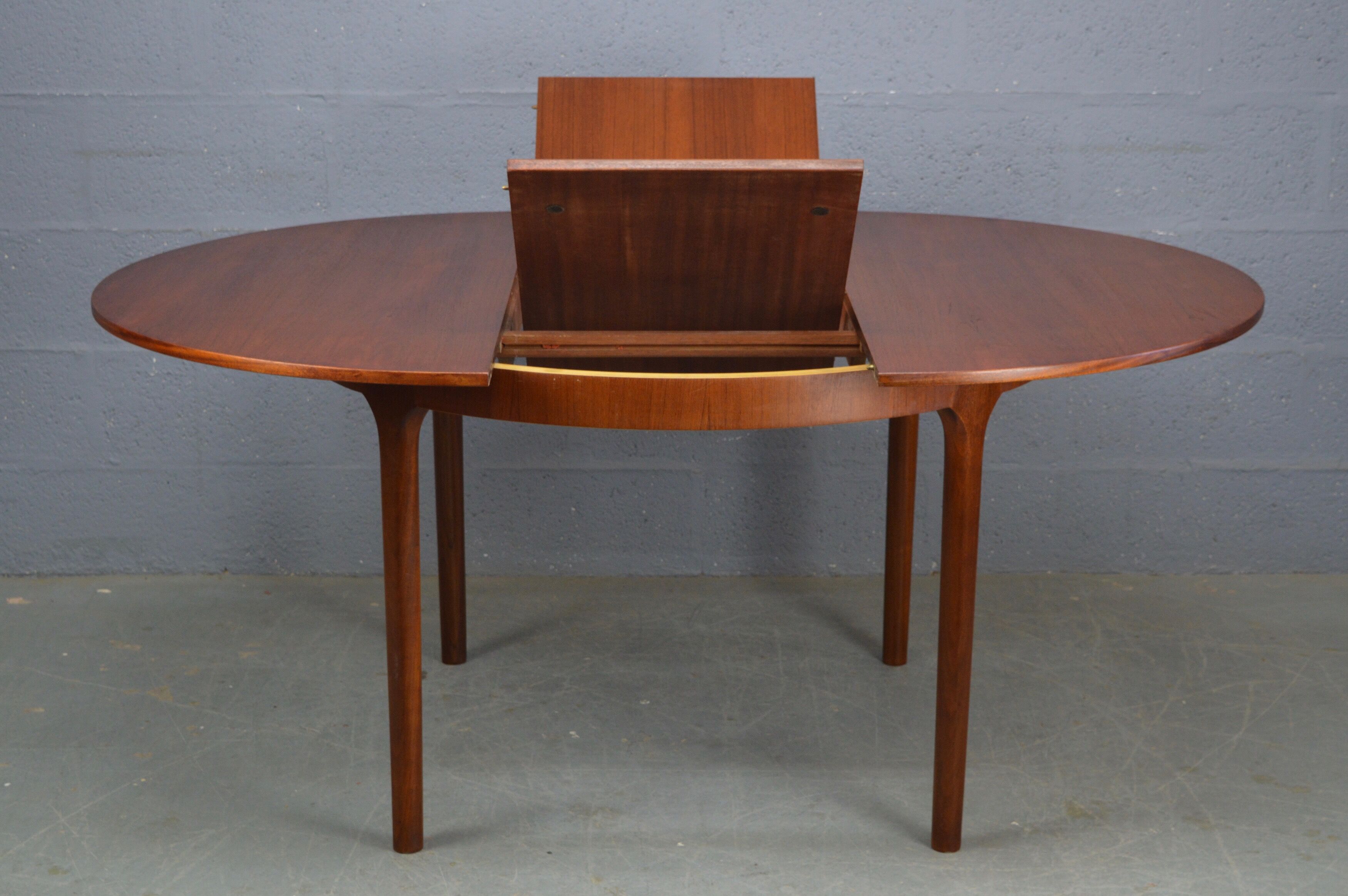 Round teak dinning table and chairs by Mctintosh