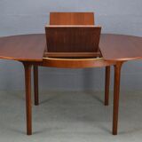 Round teak dinning table and chairs by Mctintosh