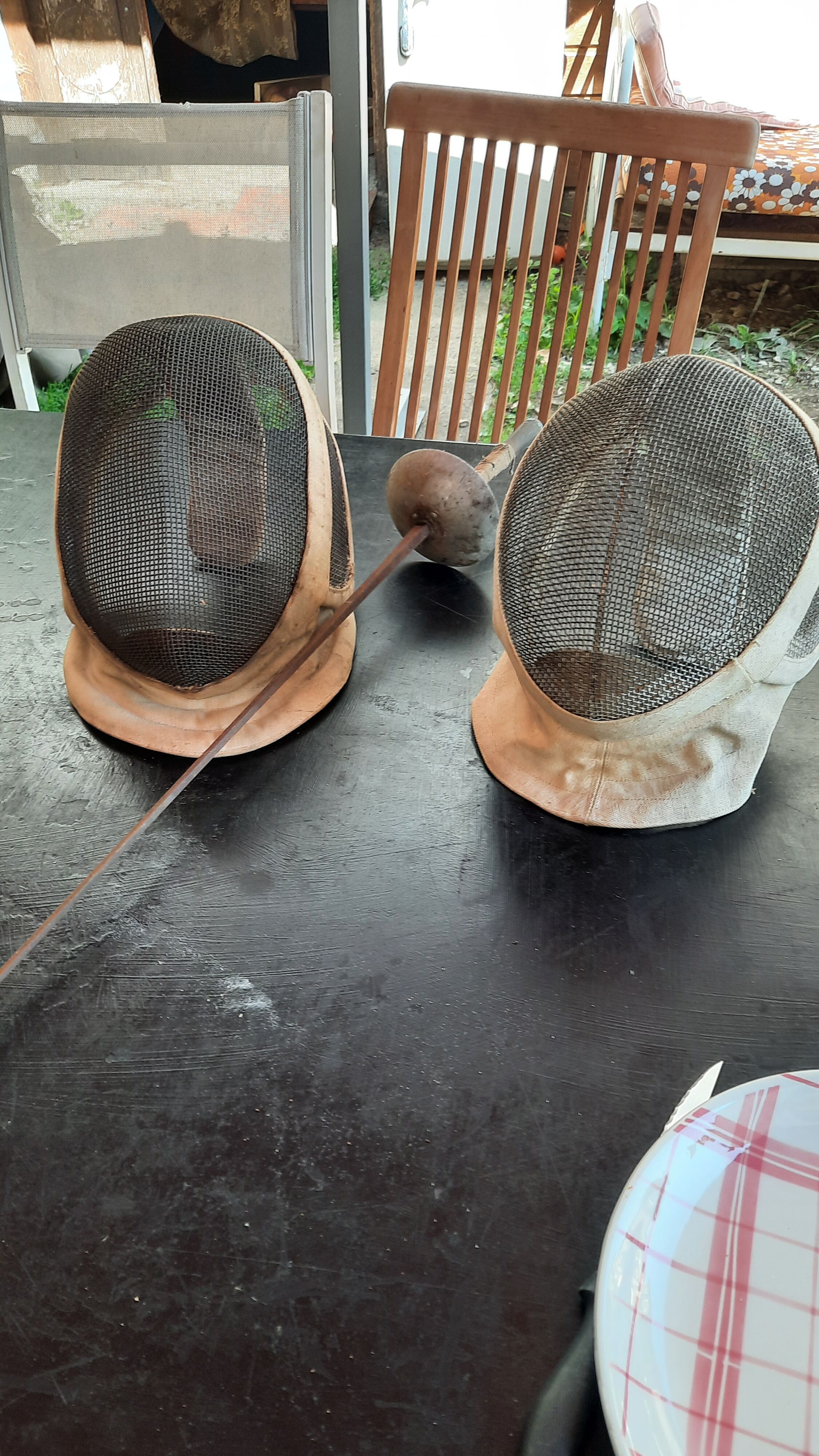 Pair of old fencing mask and foil