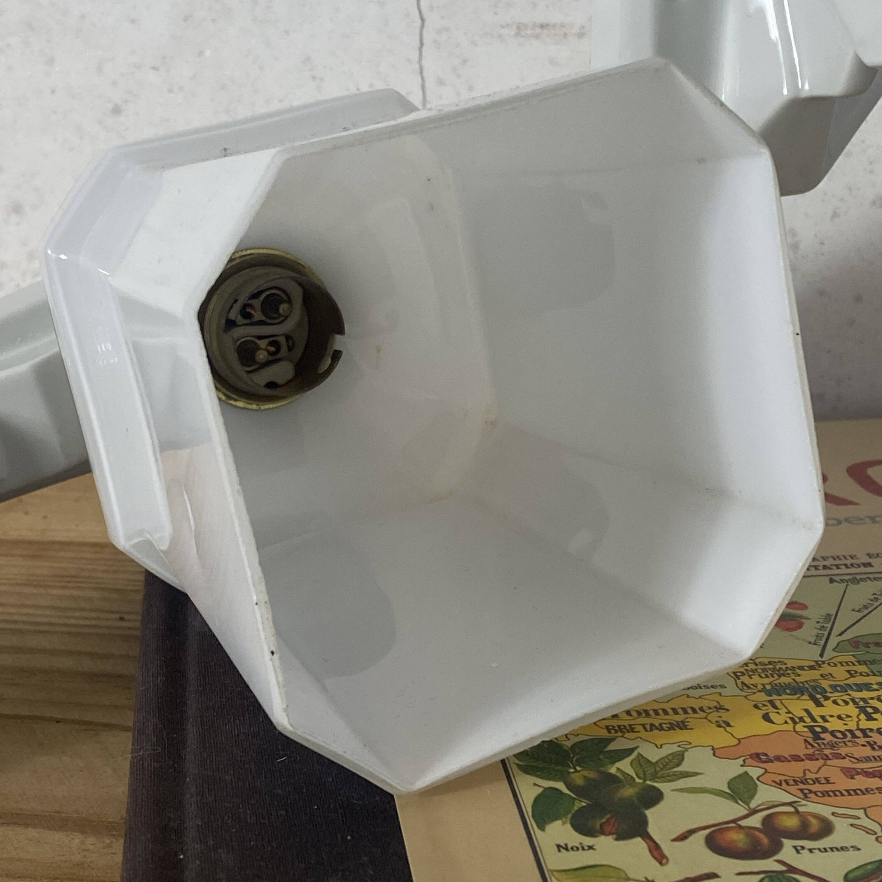 Pair of Art Deco wall sconces in ceramic with opaline glass shades.