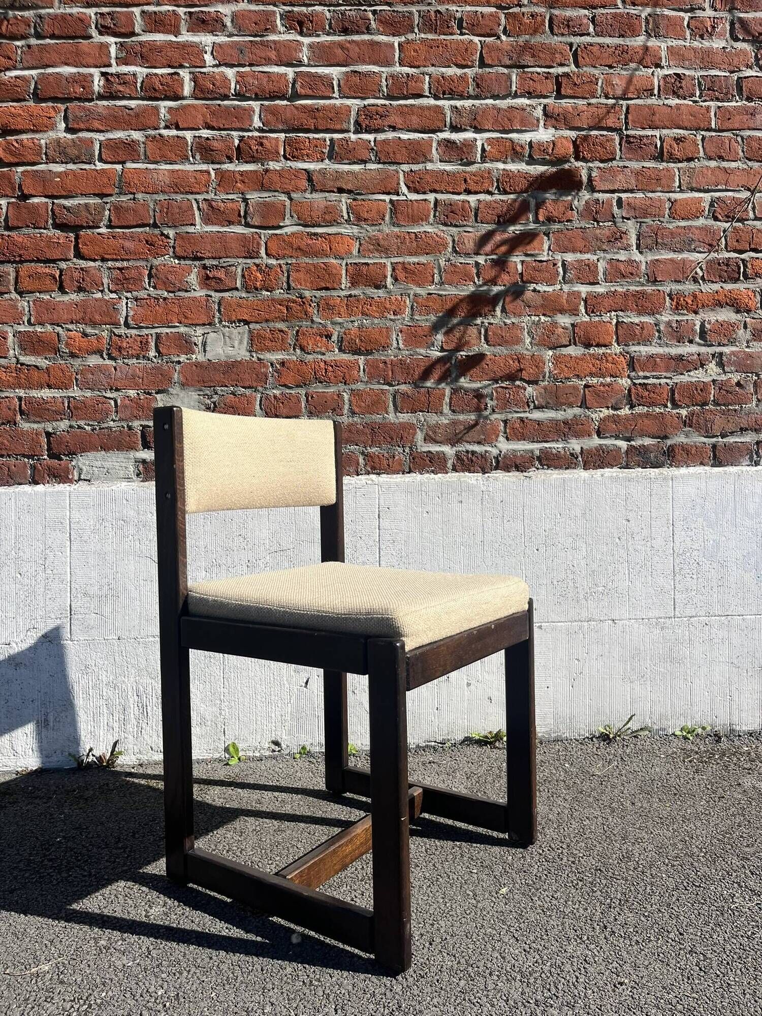 Many mid-century vintage wooden and fabric chairs.