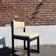 Many mid-century vintage wooden and fabric chairs.
