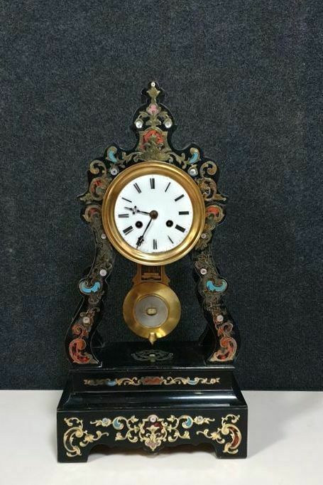 Portico clock of eventful shape of napoleon III period blackened wood inlaid with brass
