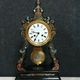 Portico clock of eventful shape of napoleon III period blackened wood inlaid with brass
