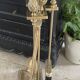Brass fireplace tools in the style of Maison Baguès.