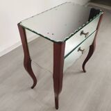 Glass art deco mirror beside table