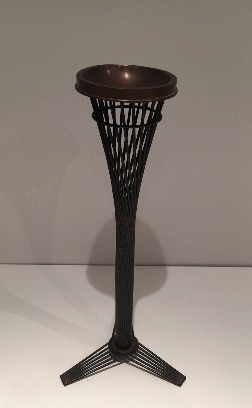 Brass ashtray on a stand made of black lacquered metal wire.