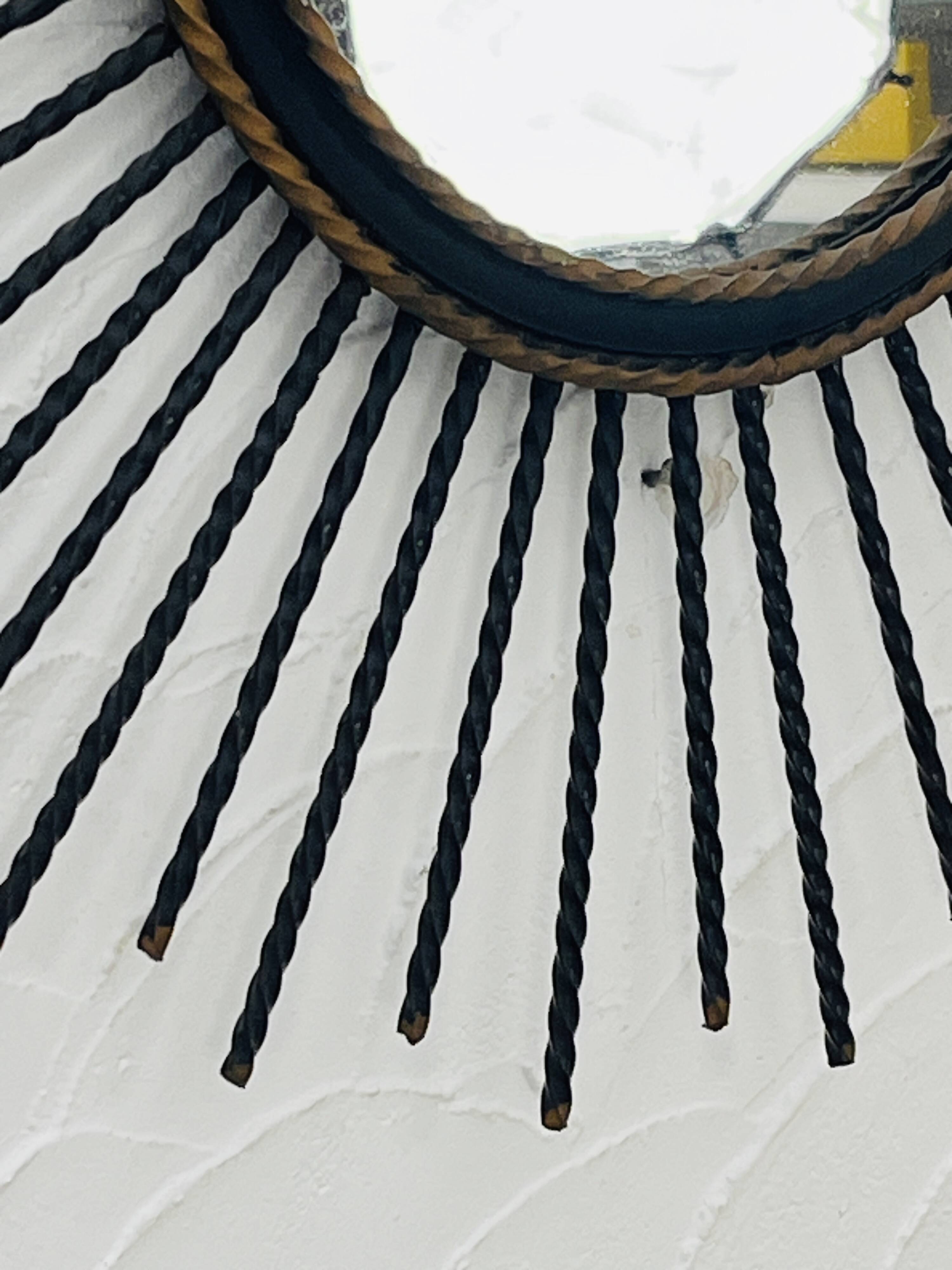 Vintage black and gold metal sun mirror from the 1960s.