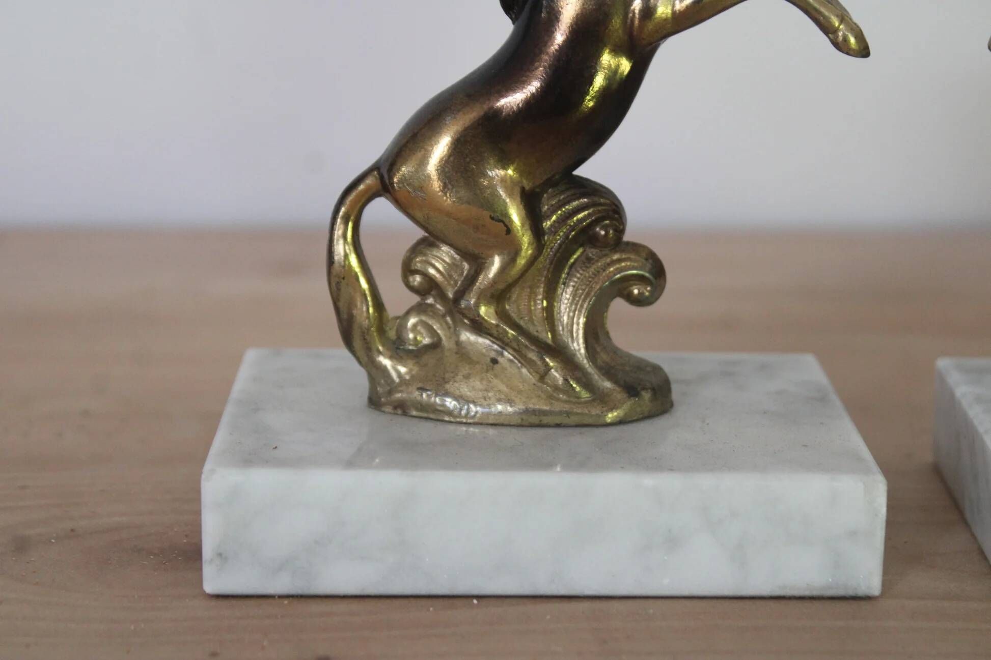 Pair of vintage bookends with rearing horses in gilded metal on marble bases.