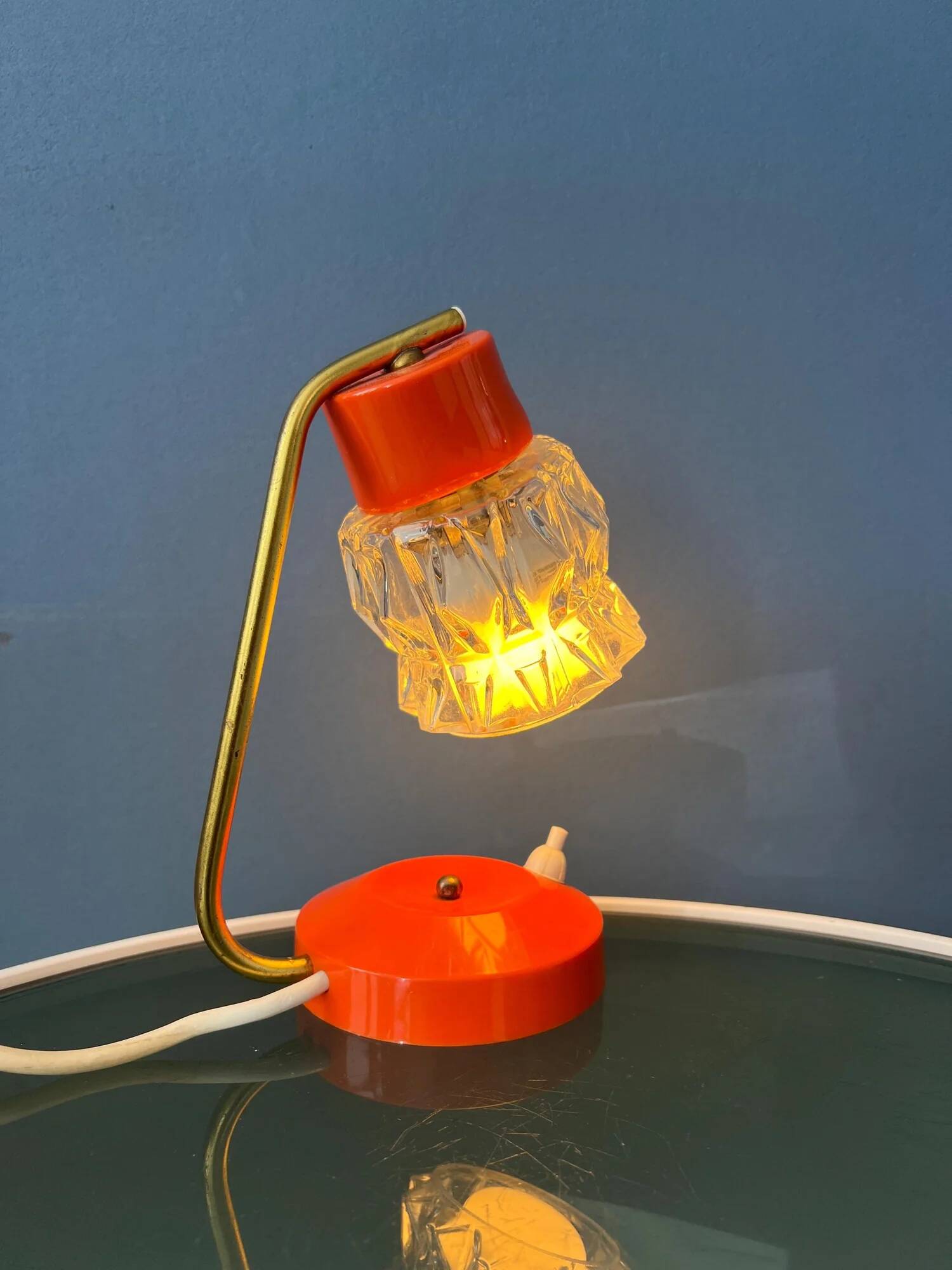 Small orange desk lamp with clear crystal glass shade