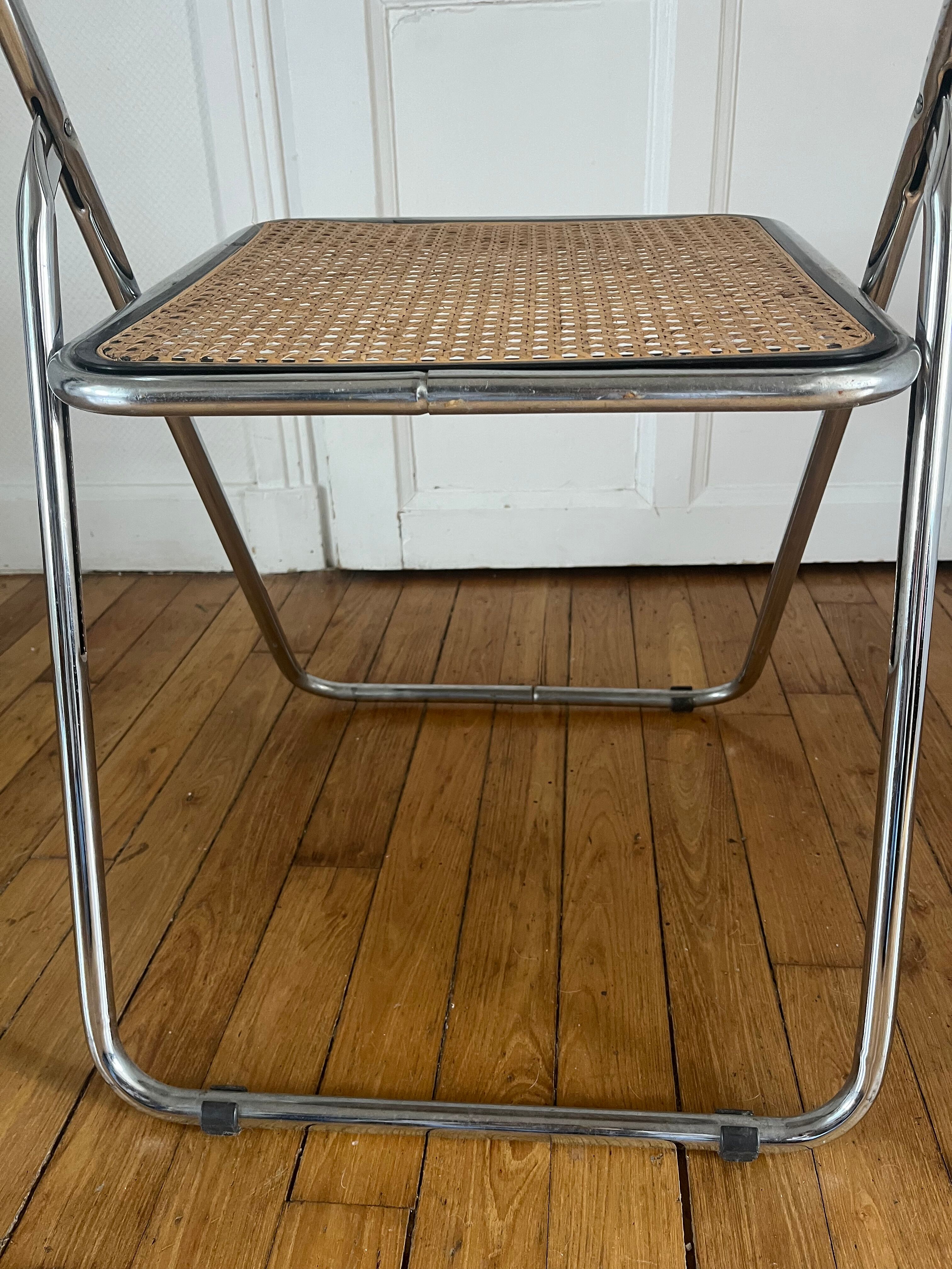 Vintage folding chair in metal and cane.