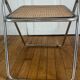 Vintage folding chair in metal and cane.