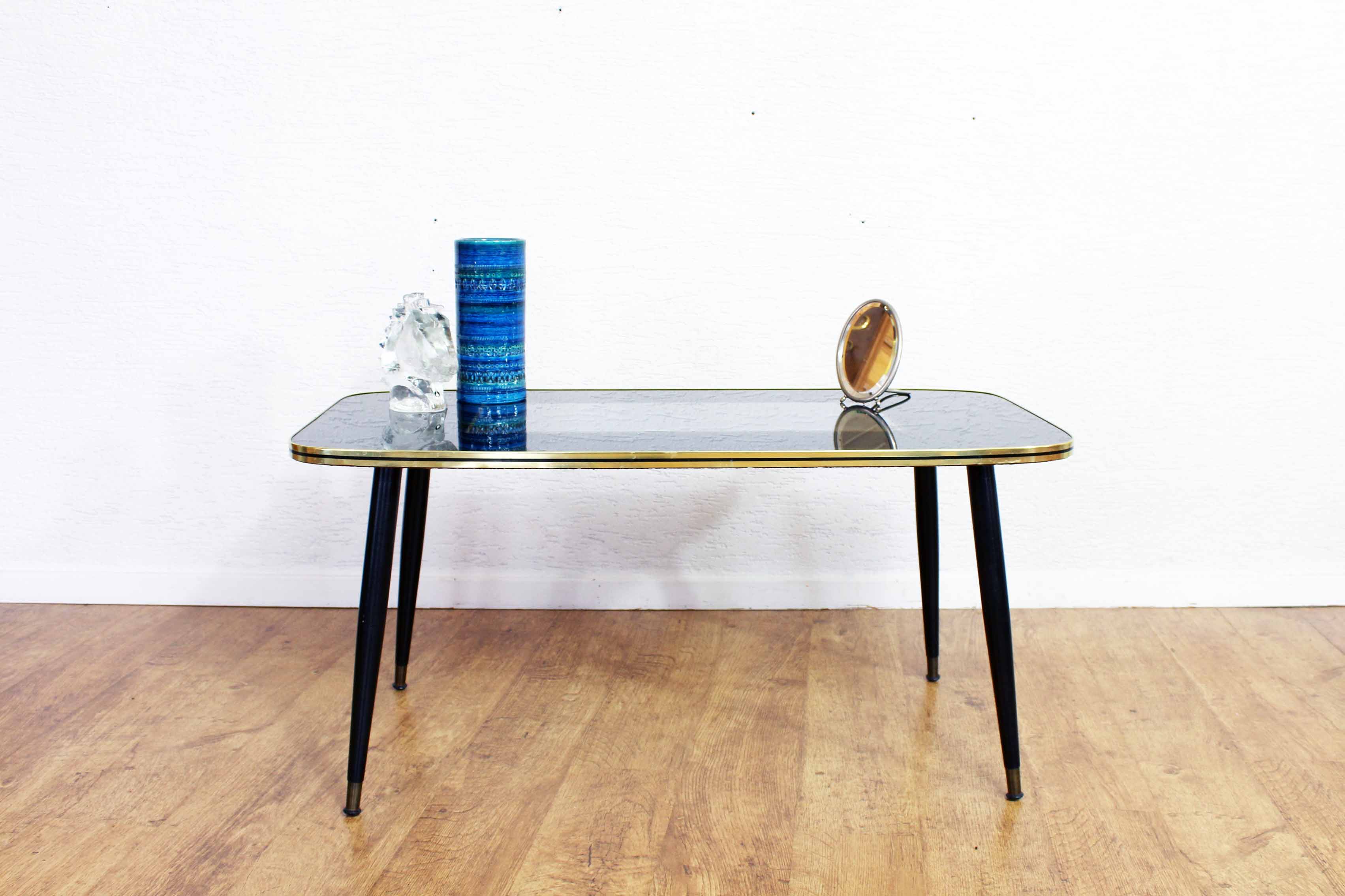 Low table with compass feet with decorative cabinet