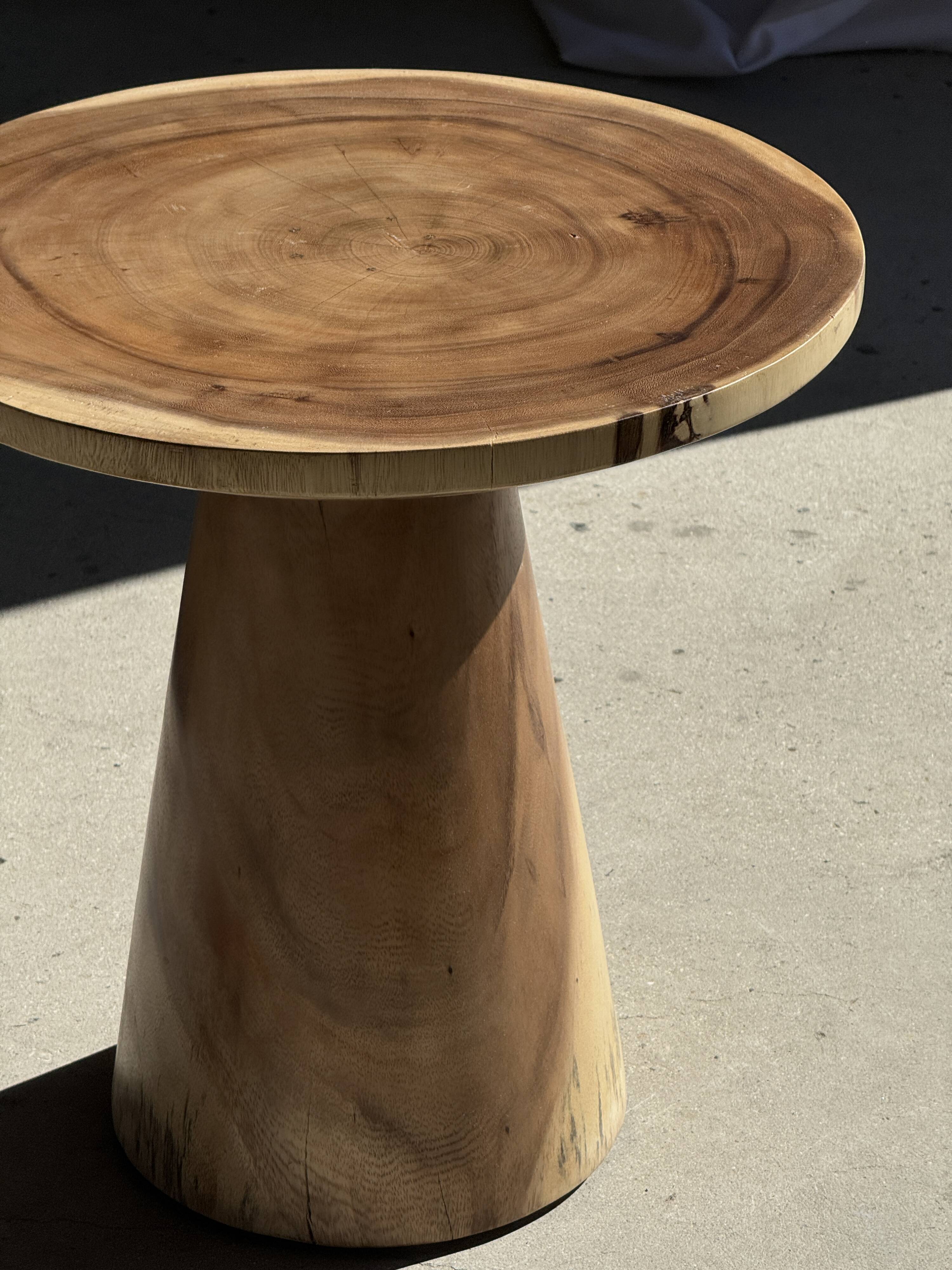Natural solid suar side table (monoxyle) with a minimal conical base.