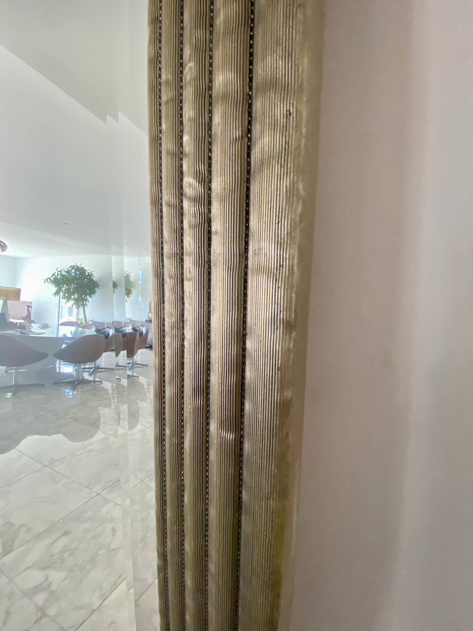 Textured embossed metal wall mirror with bevelled mirror.