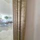 Textured embossed metal wall mirror with bevelled mirror.
