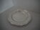 Round plate, Chinon collection with gold trim, Christofle, and its protective felt pouch.
