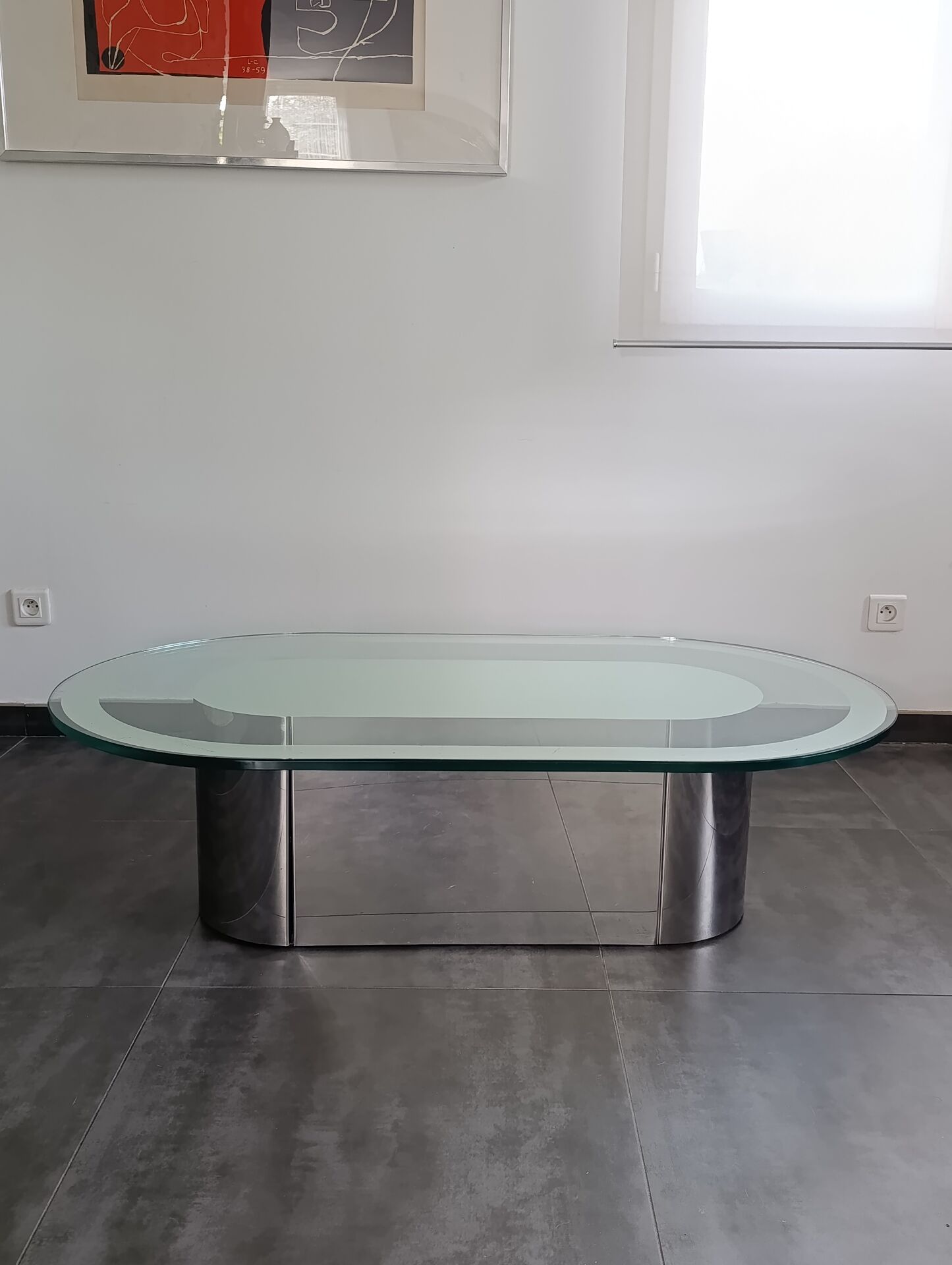 Vintage coffee table with glass and chrome metal.