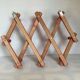 Red wood accordion coat rack