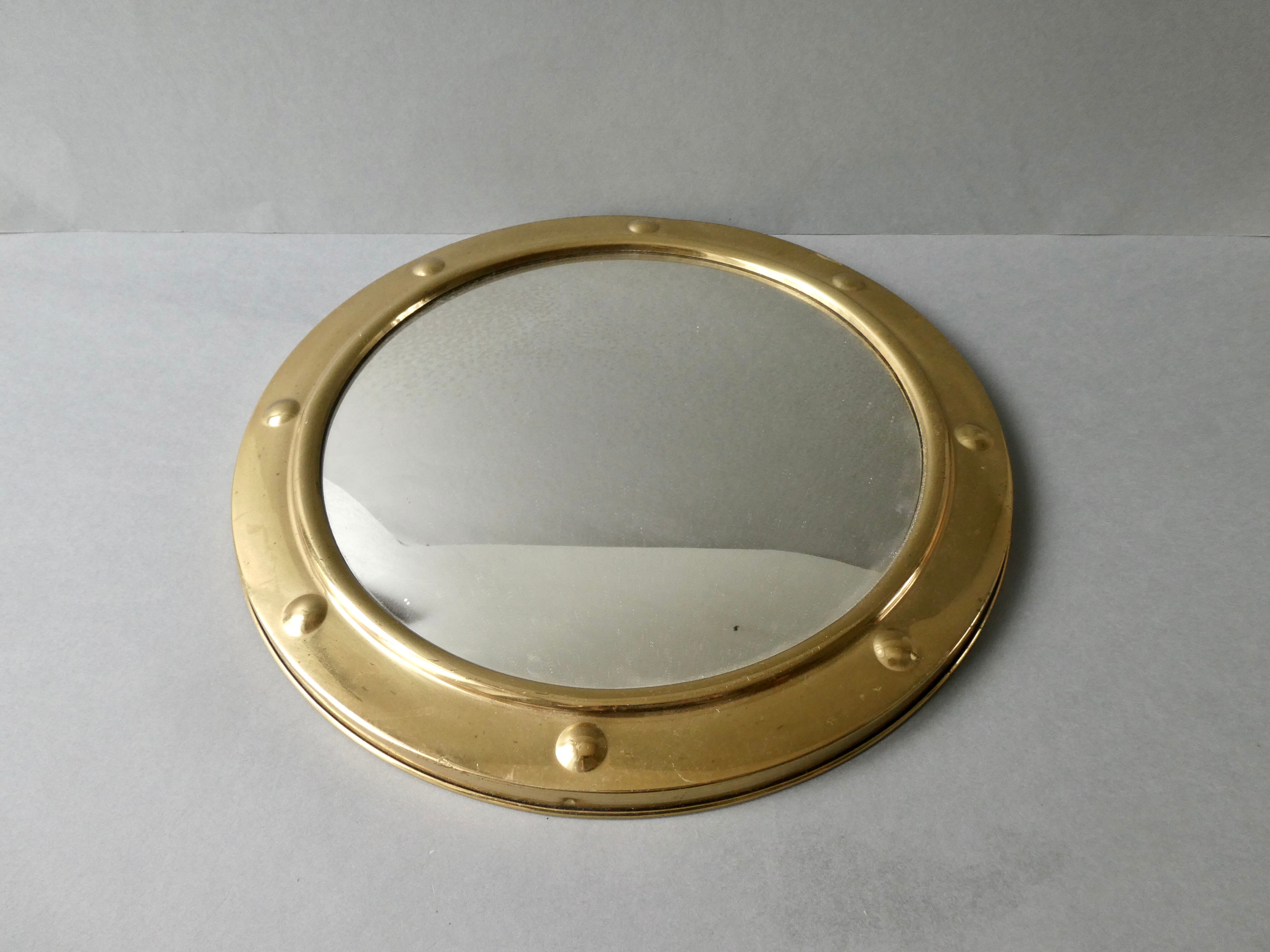 Curved mirror, in a brass porthole, 70s